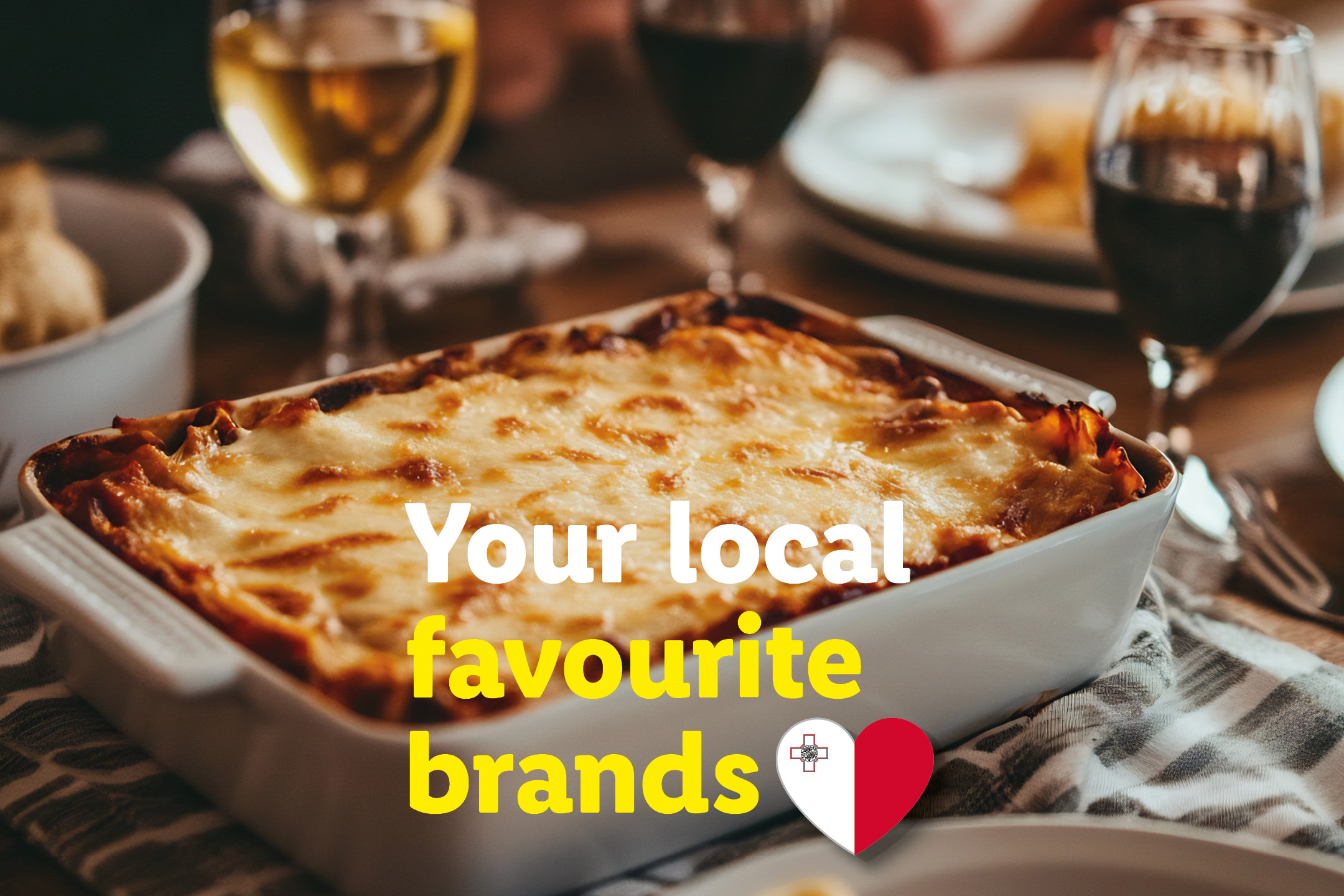 Baked lasagna in a white dish, with wine glasses and text 'Your local favourite brands'.