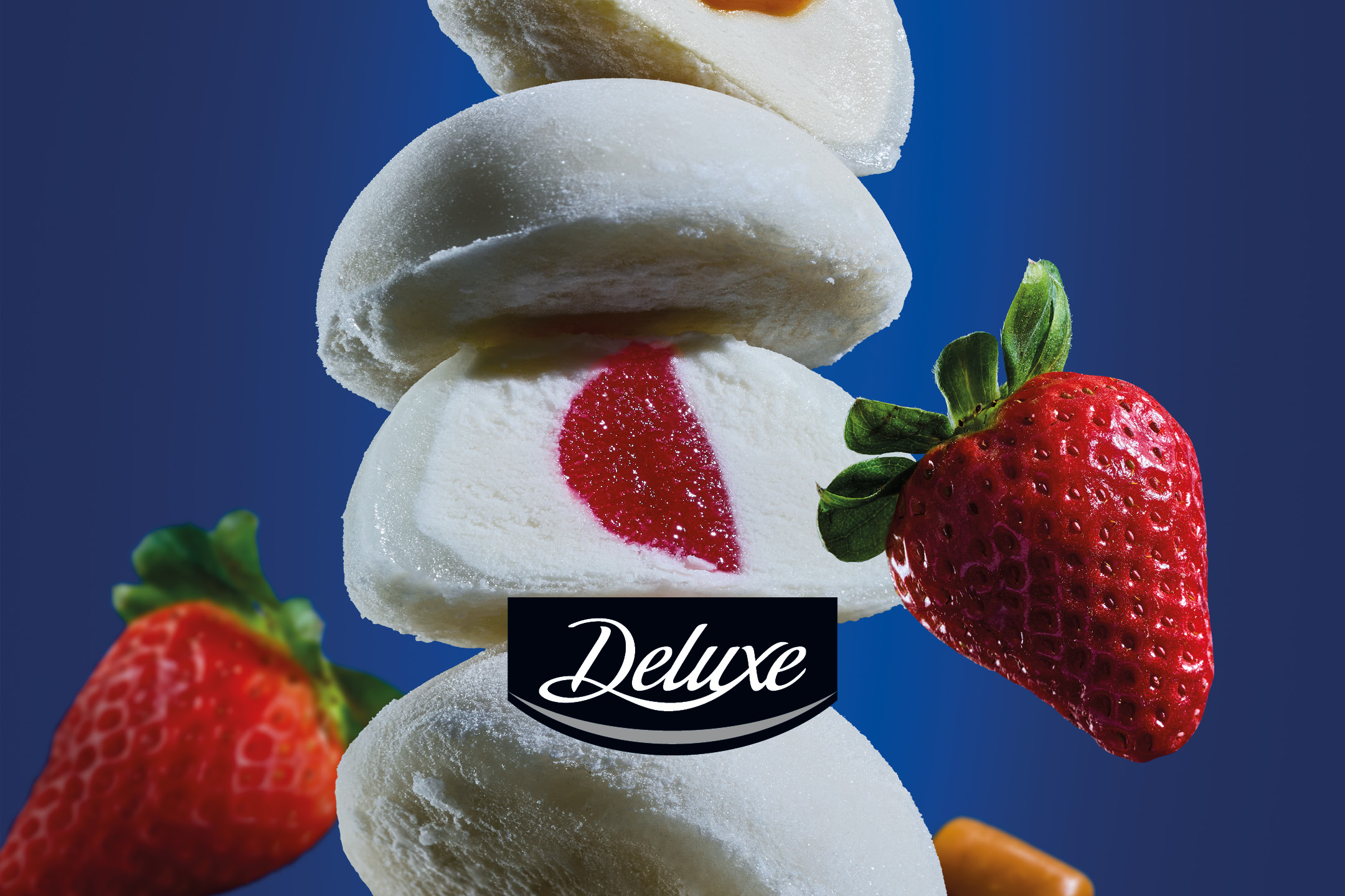 A stack of mochi ice cream, one cut open to reveal a red filling, with strawberries.