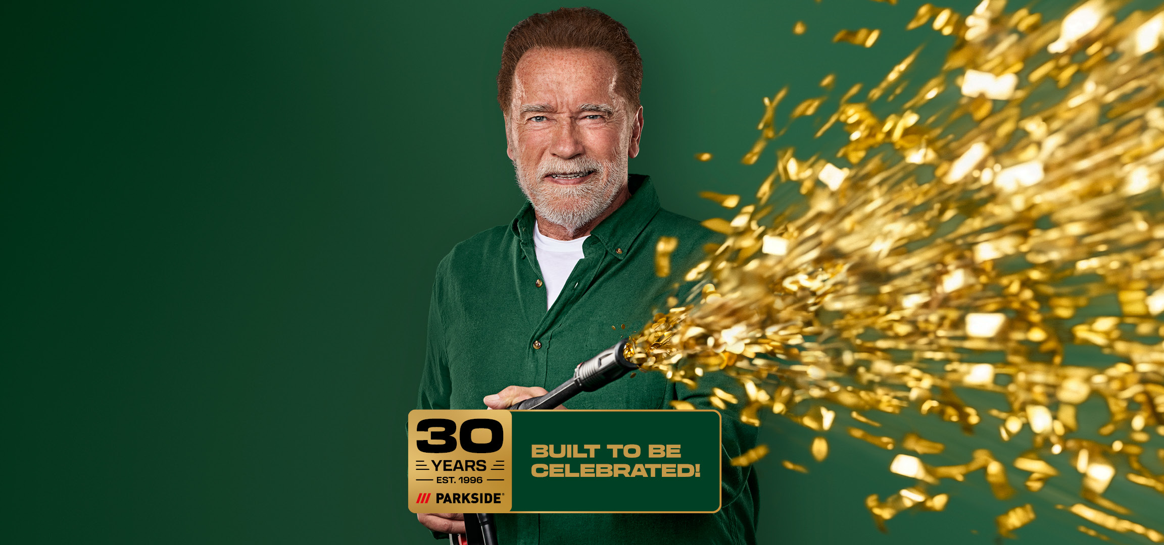 Man with a beard holding a confetti cannon, celebrating 30 years of tools.