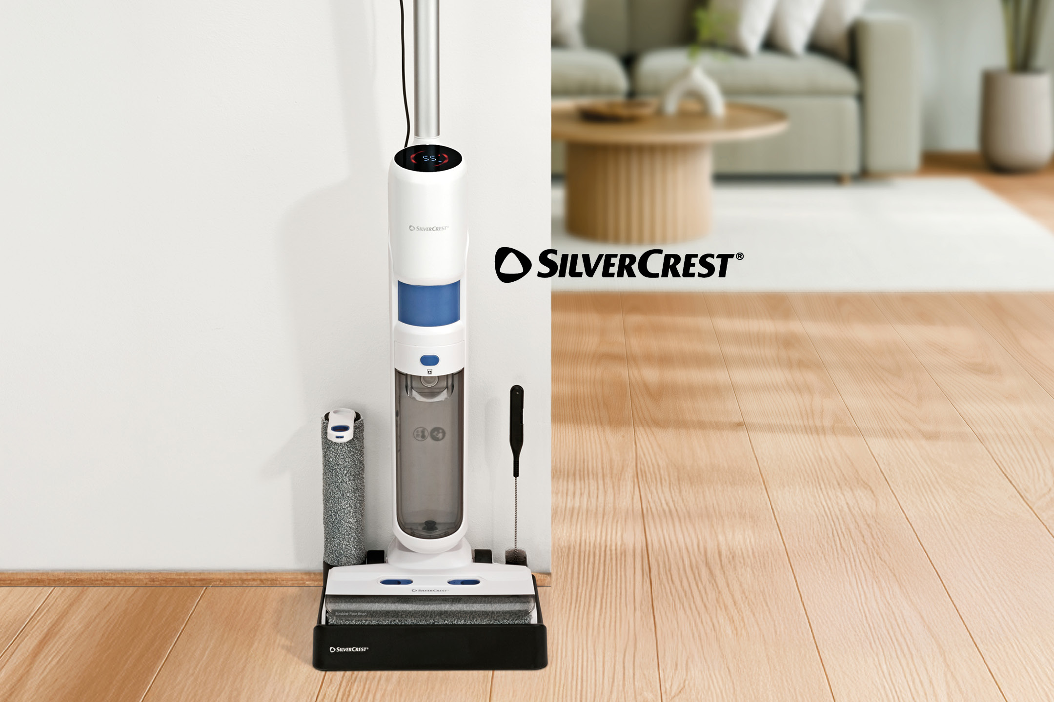 White and blue cordless wet and dry vacuum cleaner with accessories in a living room.