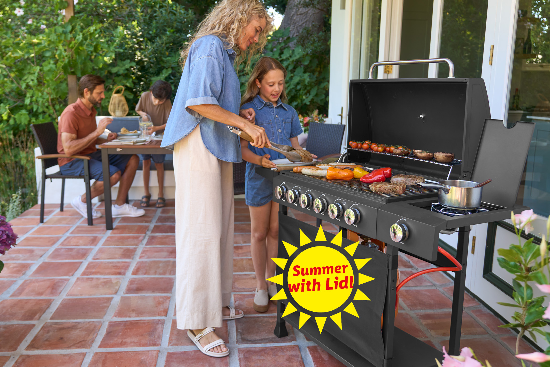 Family grilling outdoors with sausages, vegetables, and meat; 'Summer with Lidl' sun logo.