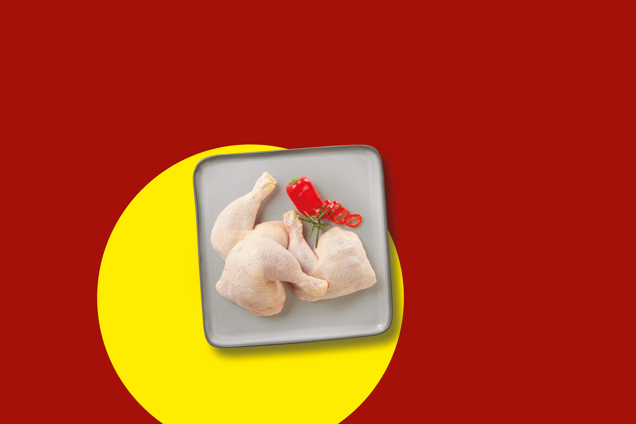 Raw chicken leg quarters with red chili and rosemary on a gray tray, red and yellow background.