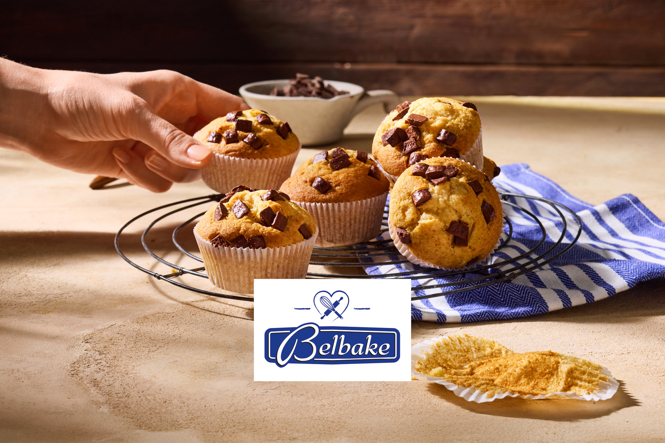 Freshly baked chocolate chip muffins cooling on a wire rack.