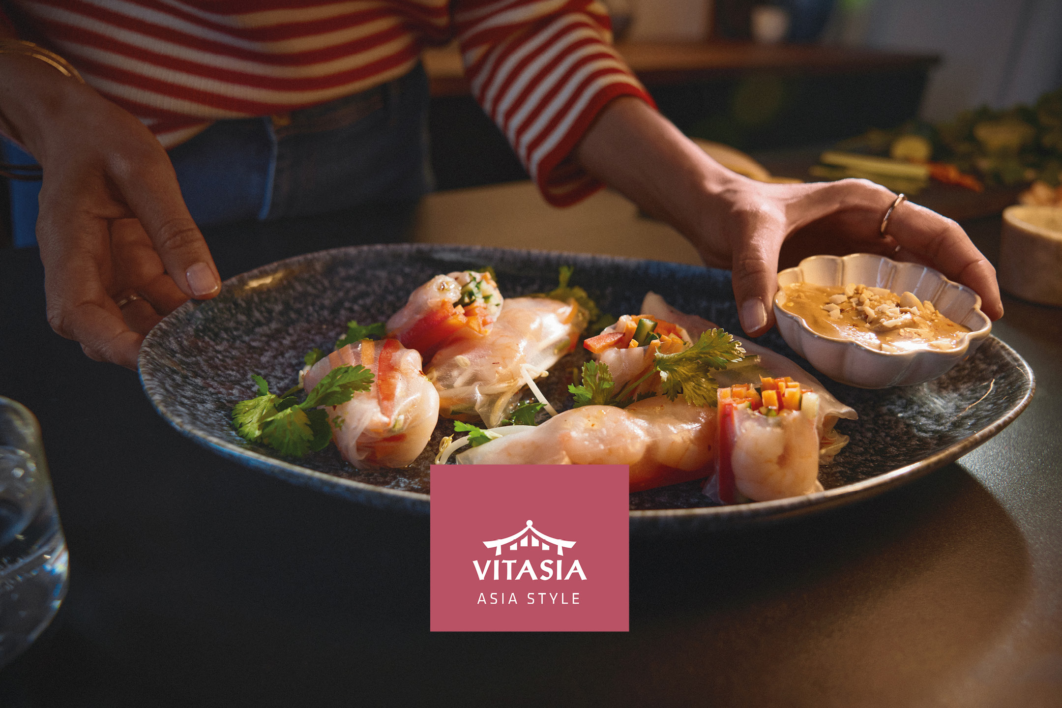 Fresh summer rolls served on a plate with peanut dipping sauce.