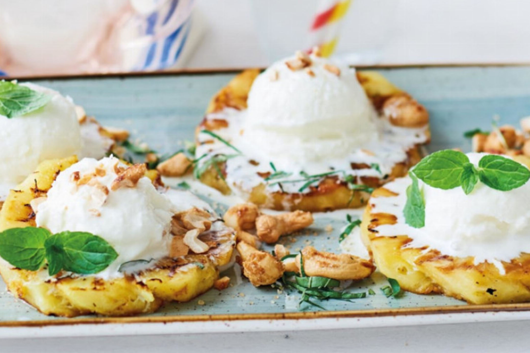 Grilled pineapple with coconut ice cream, cashews, and mint.