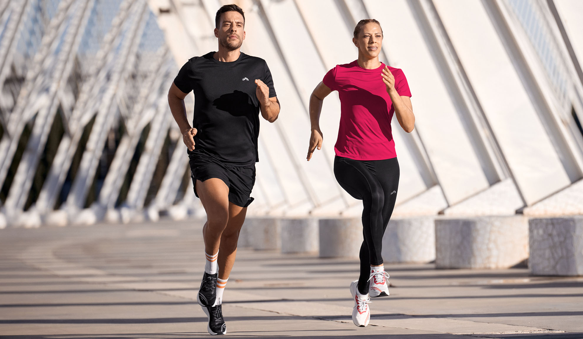 Man and woman running in sportswear, t-shirts and leggings.
