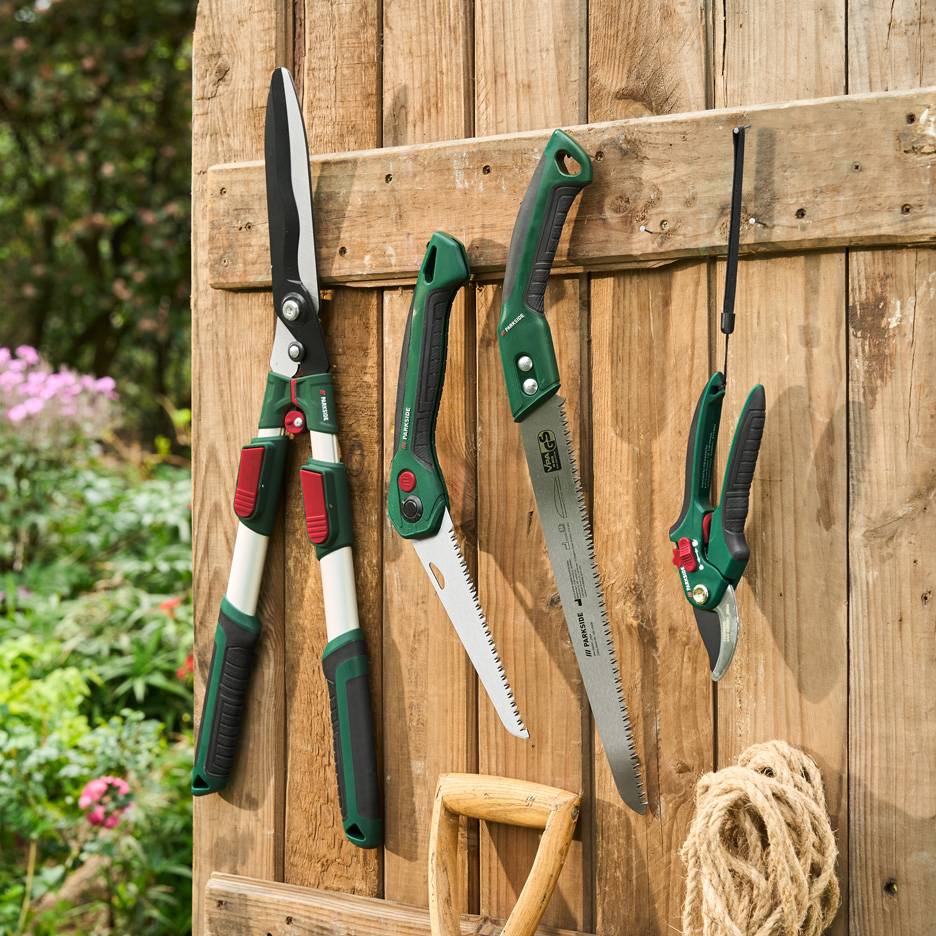 Parkside garden tools: loppers, saws, and pruning shears, on a wooden wall.